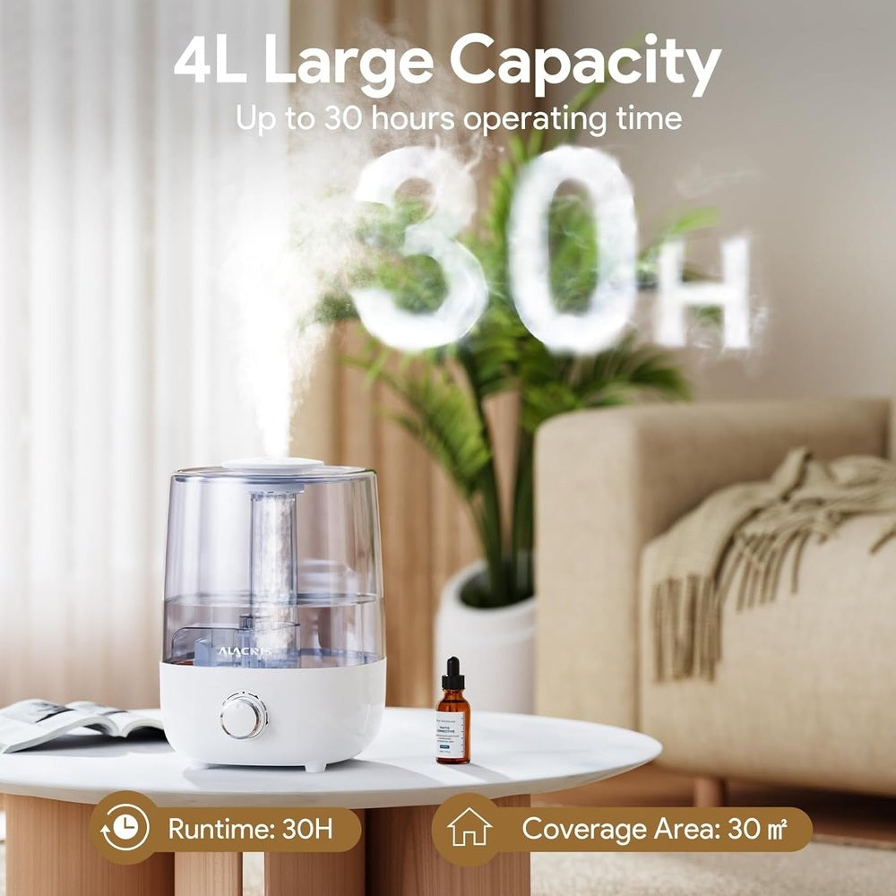 White ultrasonic cool-mist humidifier with a clear 4L tank on a round table; amber essential oil bottle nearby.