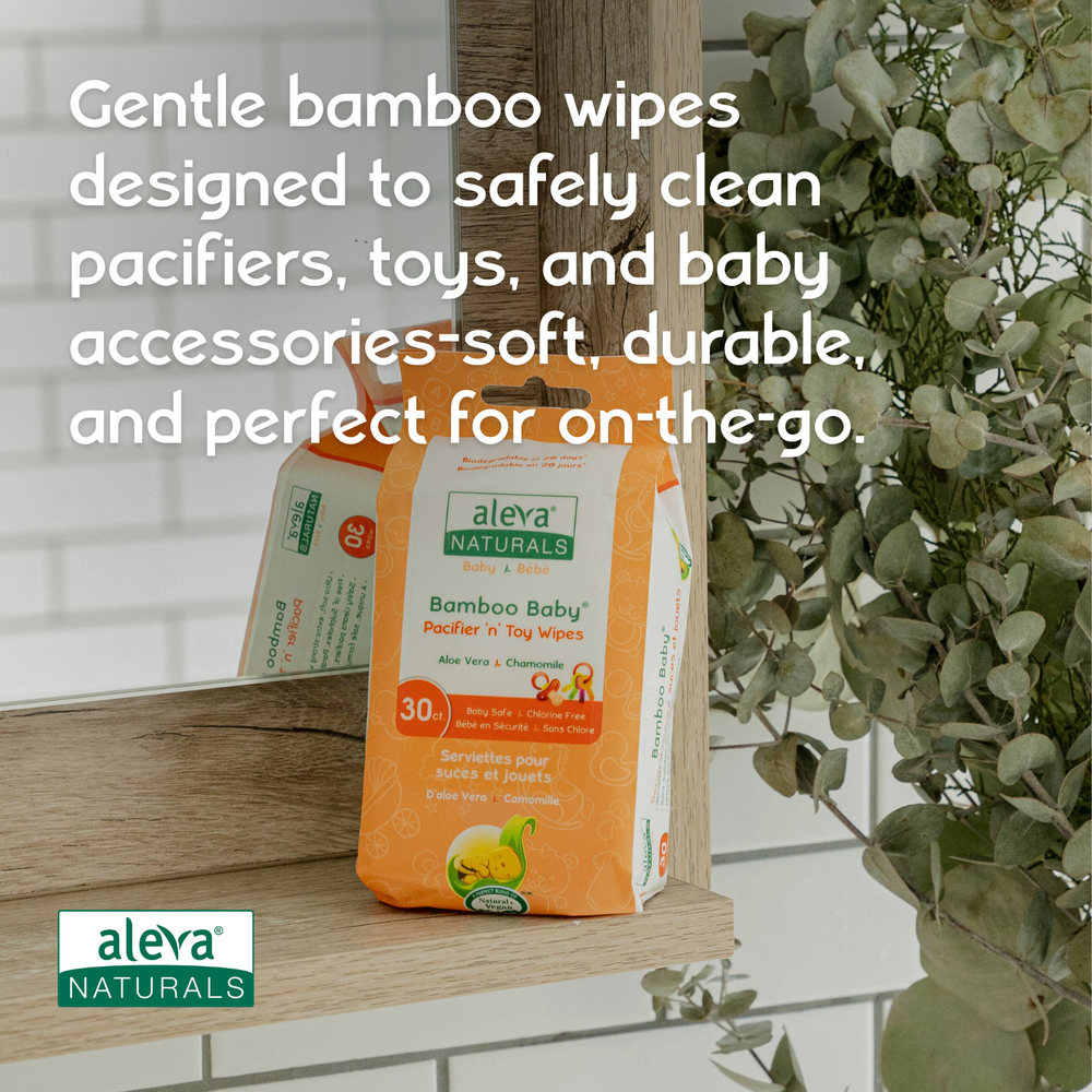 Aleva Naturals Bamboo Baby Pacifier and Toy Wipes in Orange packaging with green logo, front view on wood shelf.