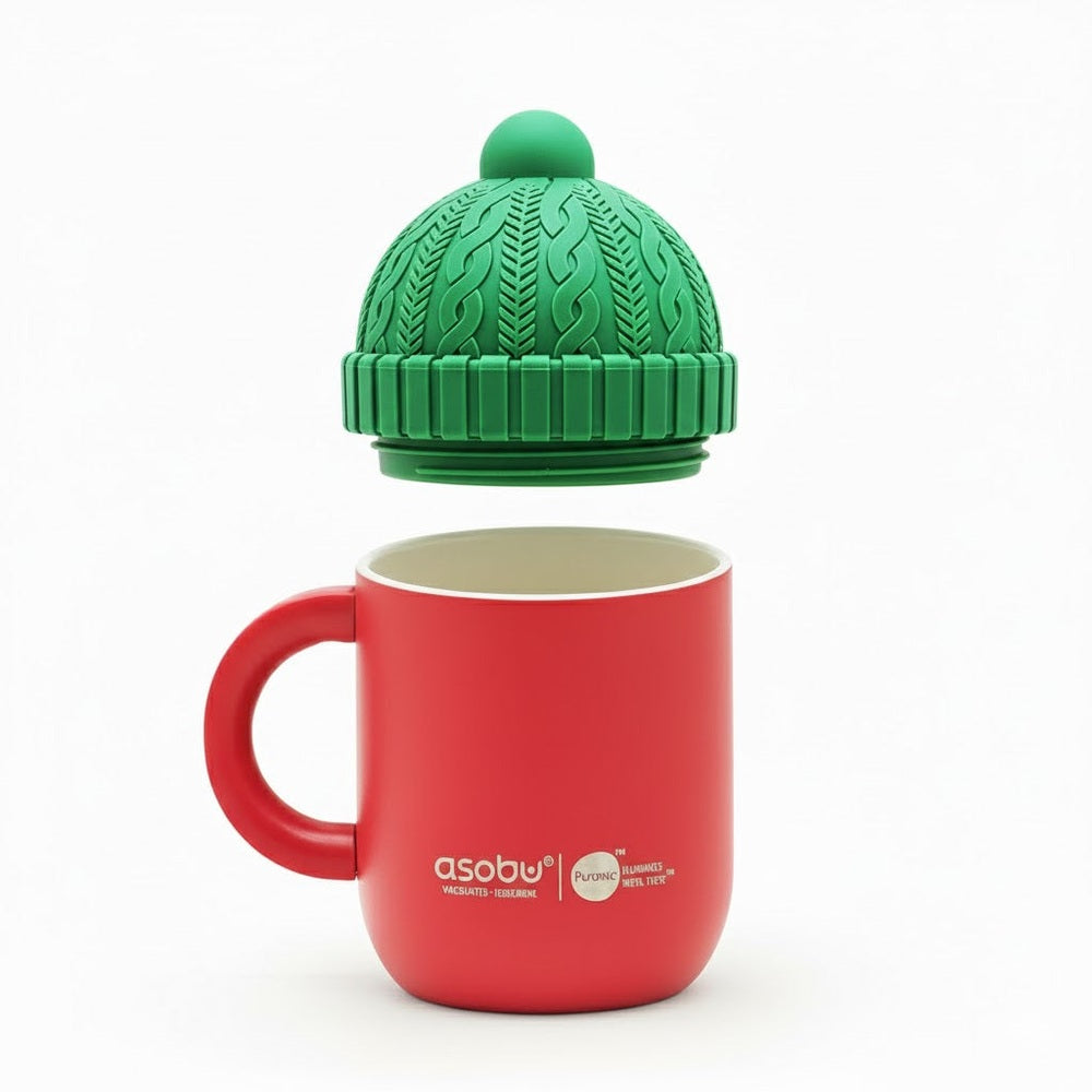 Red mug with green knit-style lid on a white background
