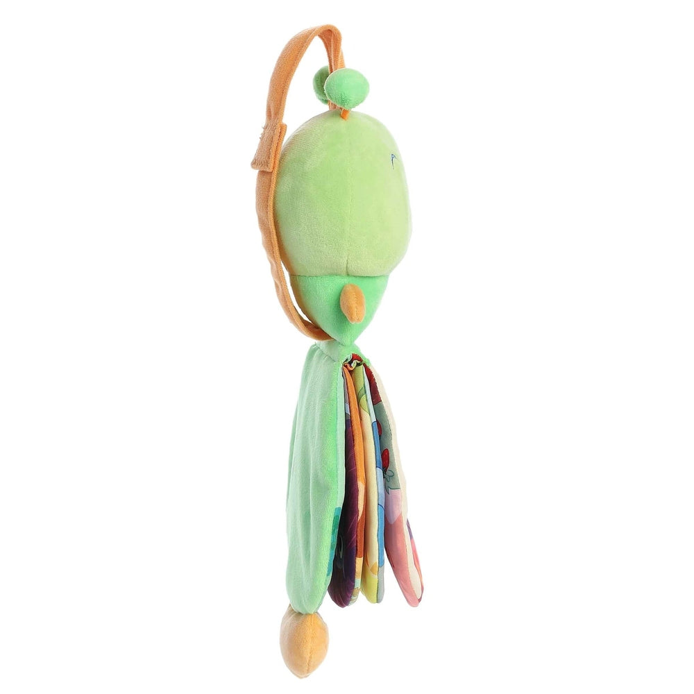 Green plush Story Pal hanging toy with tan strap and rainbow fabric pages.
