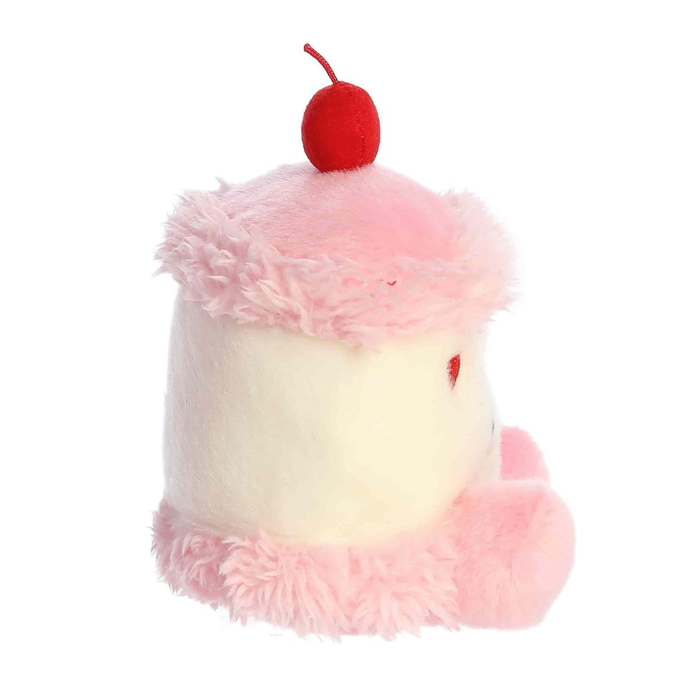 Aurora Palm Pals Jubi Heart Cake plush toy, pink and white fur with red cherry accent