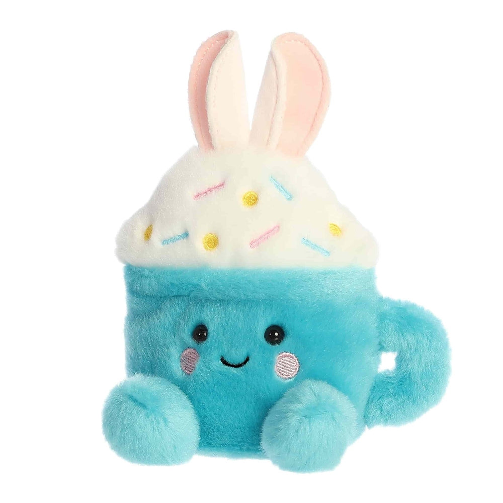 Aurora Palm Pals Lopi Bunny Latte plush: blue cup with bunny ears, white topping, pastel sprinkles.