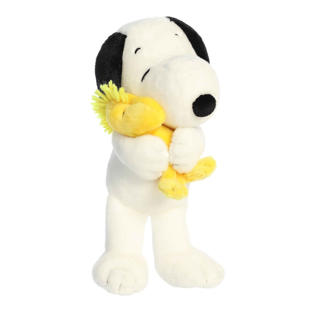 Snoopy and Woodstock plush set, 12" Aurora stuffed animals; white Snoopy hugging yellow Woodstock.