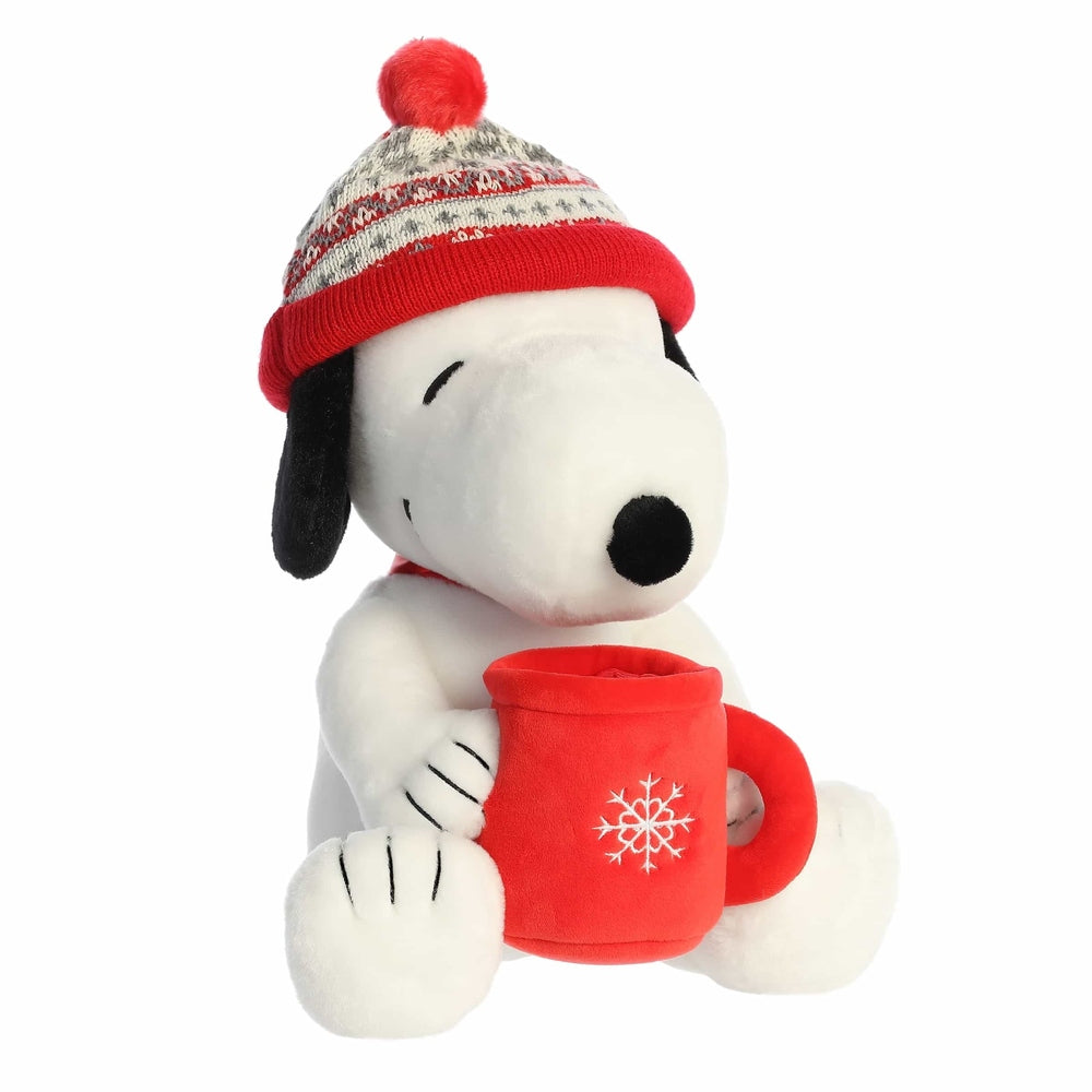 Aurora Snoopy 12-inch stuffed animal in a red knit winter hat, holding a red mug with a snowflake