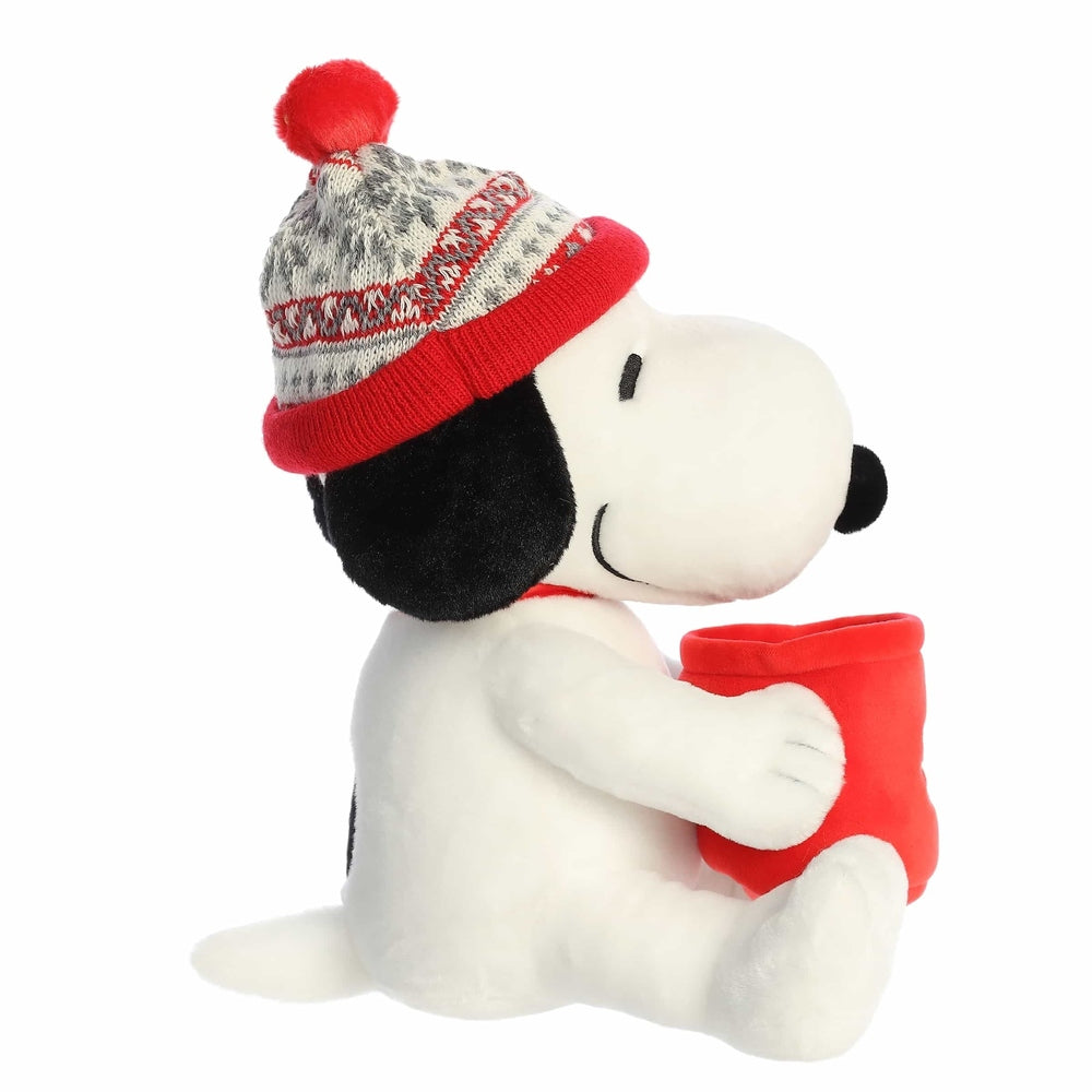 Aurora Snoopy plush stuffed animal holding a red mug, wearing a red-and-gray knit winter hat with pom