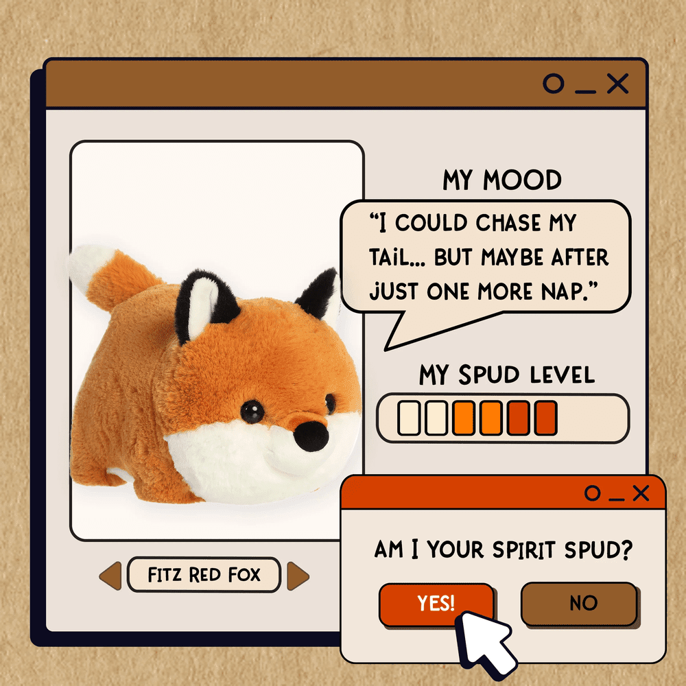 Aurora Spudsters Fitz Red Fox 10" plush toy resting on a cartoon computer panel, showcasing its soft, cuddly fur.
