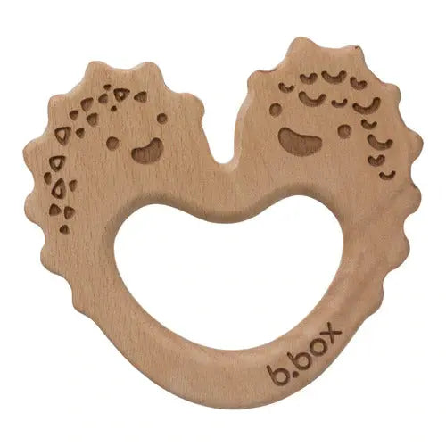 B.Box Trio Teether, natural wood ring with two smiling faces forming a heart cutout and visible brand logo.