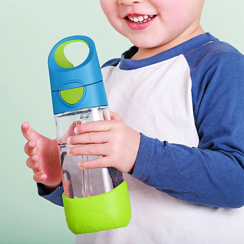 B.Box Tritan Drink Bottle held by a smiling child, blue with lime-green cap and base, BPA-free clear bottle.