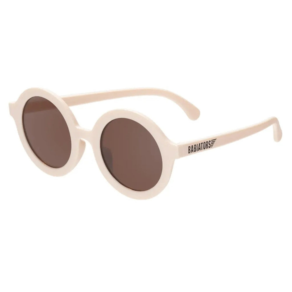 Babiators Euro Round Sweet Cream sunglasses with brown lenses; kid-sized ivory round frames shown with logoed temple.