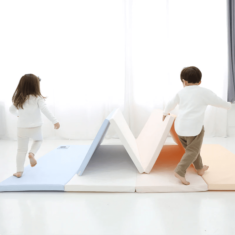 DWINGULER Baby Care Premium Tumbling Folding Mat Large Pastel Blue with pink sections; children climb and balance on the soft mats.