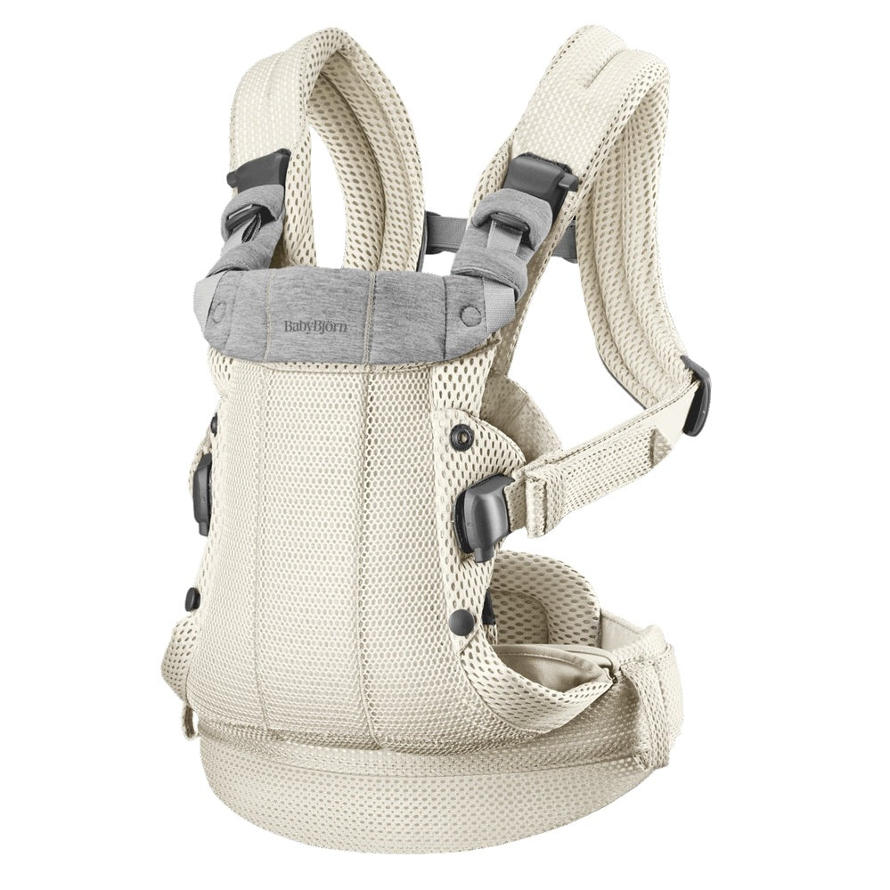 BabyBjorn Harmony baby carrier in beige with padded straps and breathable mesh, shown ready to wear.