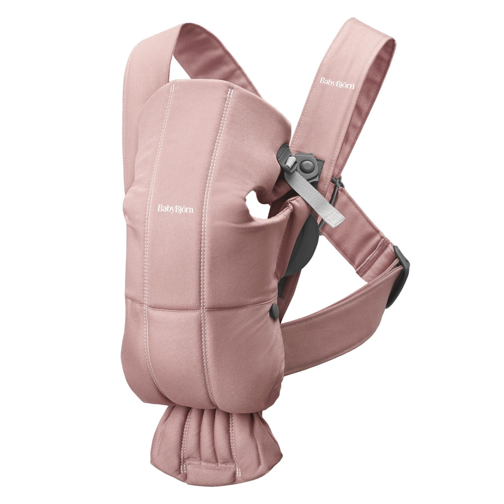 BabyBjorn Baby Carrier Mini in dusty pink with padded seat and adjustable straps, waist belt visible.