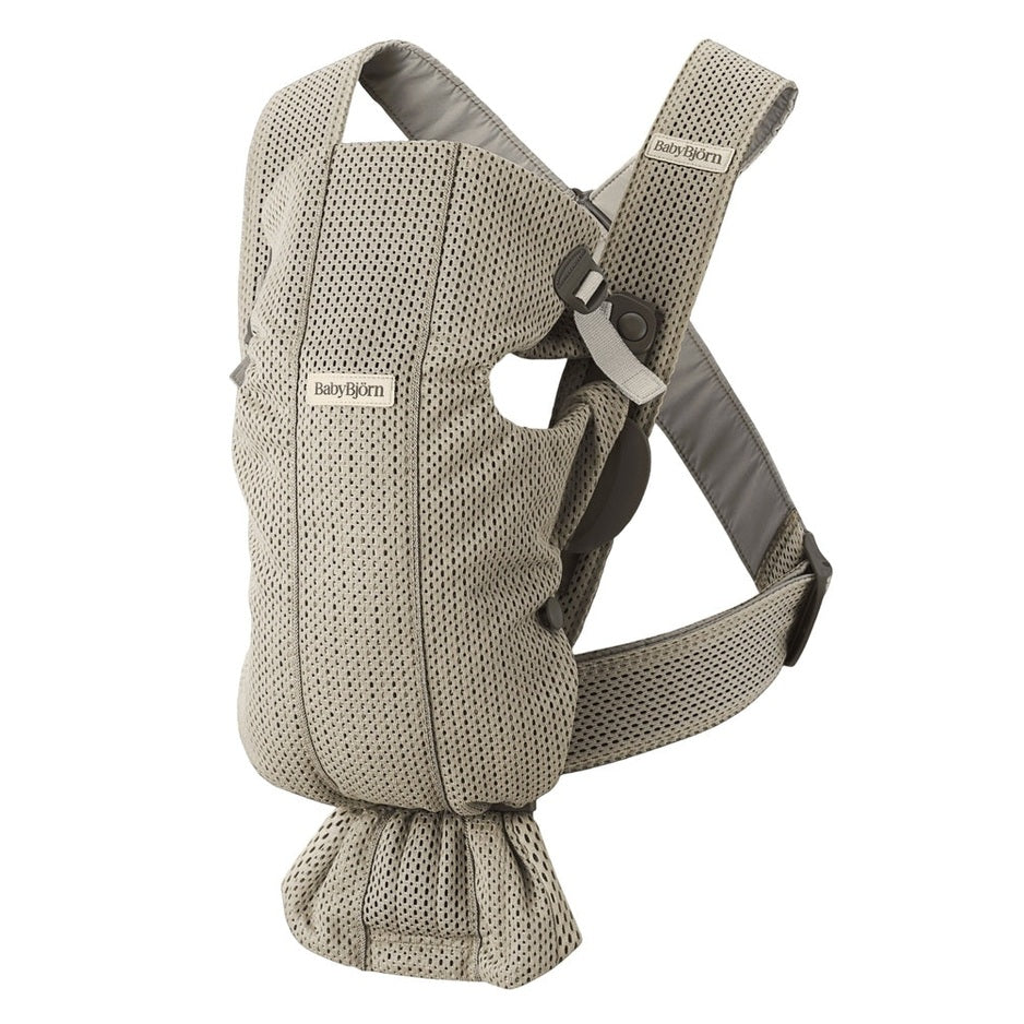 BabyBjorn Baby Carrier Mini in beige mesh, featuring padded straps and adjustable buckles ready to wear.