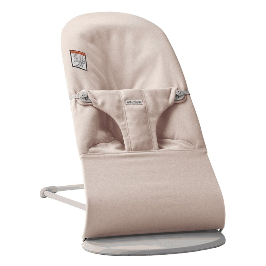 BabyBjorn Bouncer Bliss beige fabric baby bouncer resting on its curved base with padded seat and safety harness.