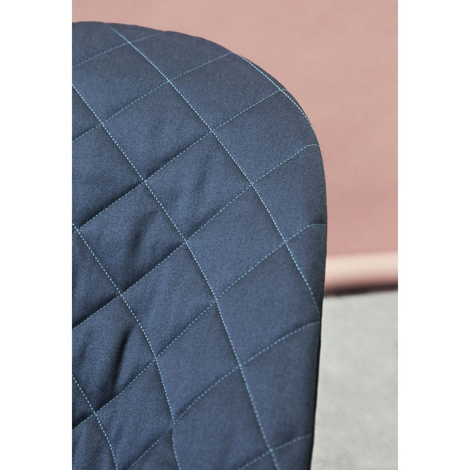 BabyBjorn Bouncer Bliss navy quilted fabric close-up showcasing a soft padded seat with grid stitching.