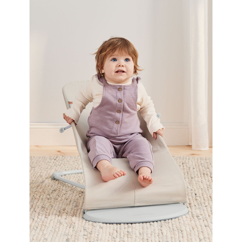 BabyBjorn Bouncer Bliss infant bouncer in beige, baby sits securely in the curved rocker.
