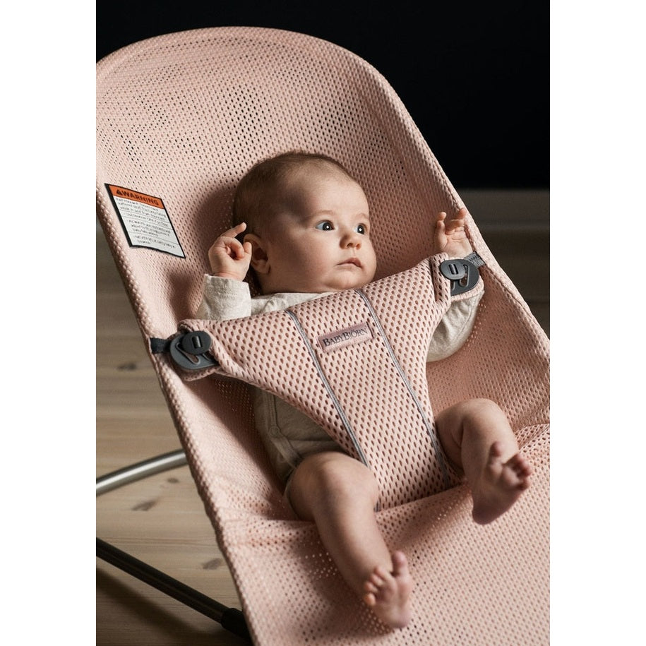 BabyBjorn Bouncer Bliss pink mesh baby bouncer; baby reclines securely in the harness with relaxed limbs.