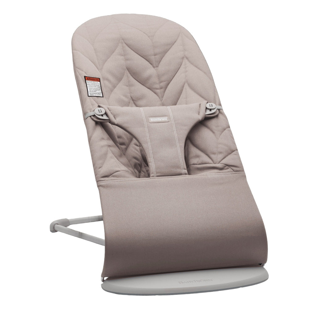 BabyBjorn Bouncer Bliss in beige fabric secured on its frame, showing cushioned seat and safety harness.