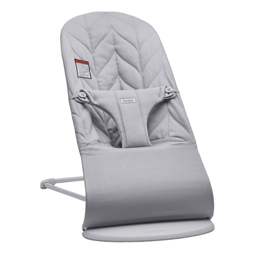 BabyBjorn Bouncer Bliss in gray with padded seat and 3-point harness on a round base for gentle rocking.