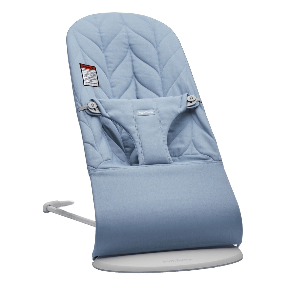 BabyBjorn Bouncer Bliss blue quilted seat on a white base, demonstrating the gentle rocking motion.