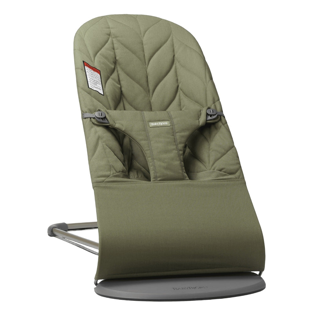BabyBjorn Bouncer Bliss in olive green, attached to its metal stand with a quilted seat and safety harness.
