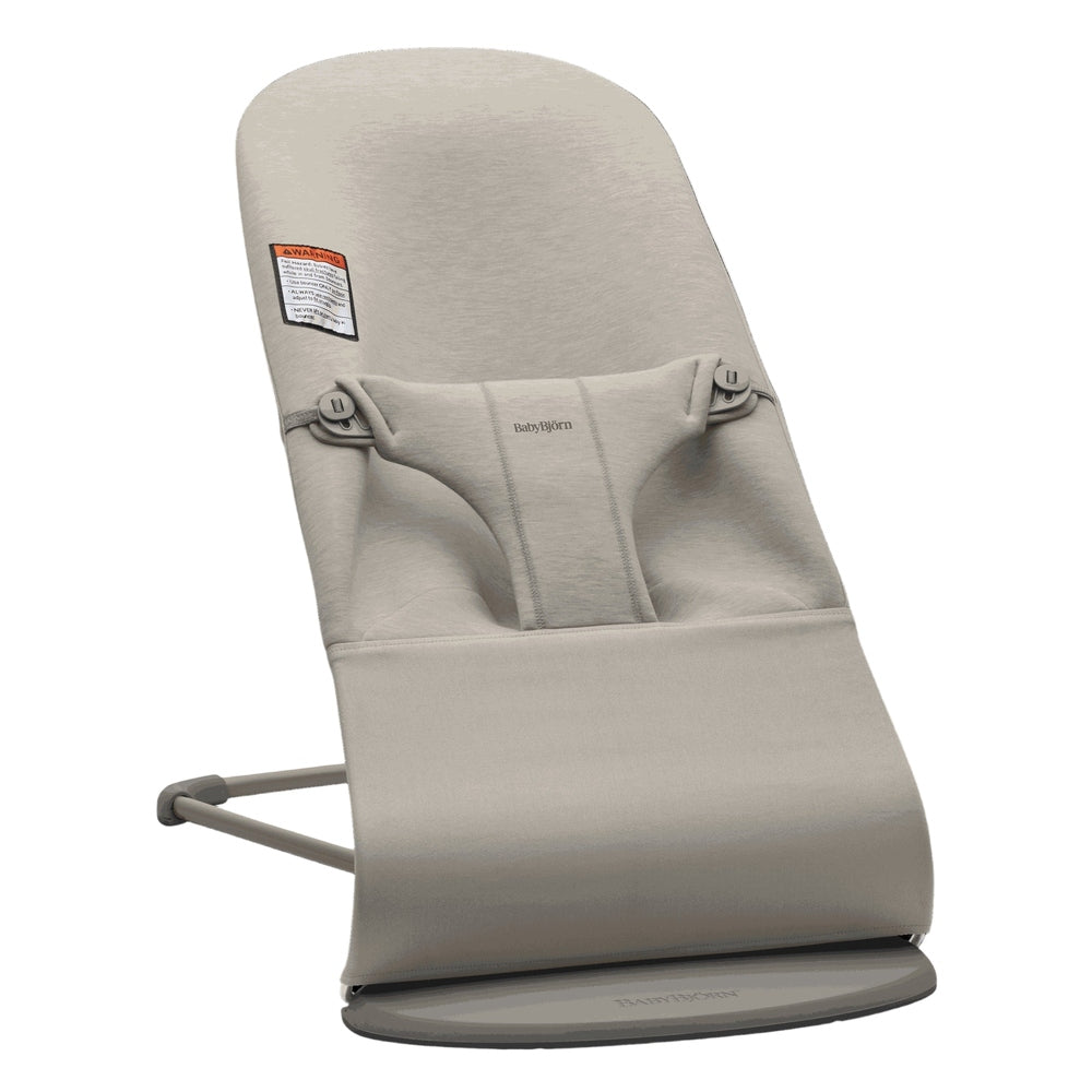 BabyBjorn Bouncer Bliss in beige, soft fabric with harness, resting on its round circular base.
