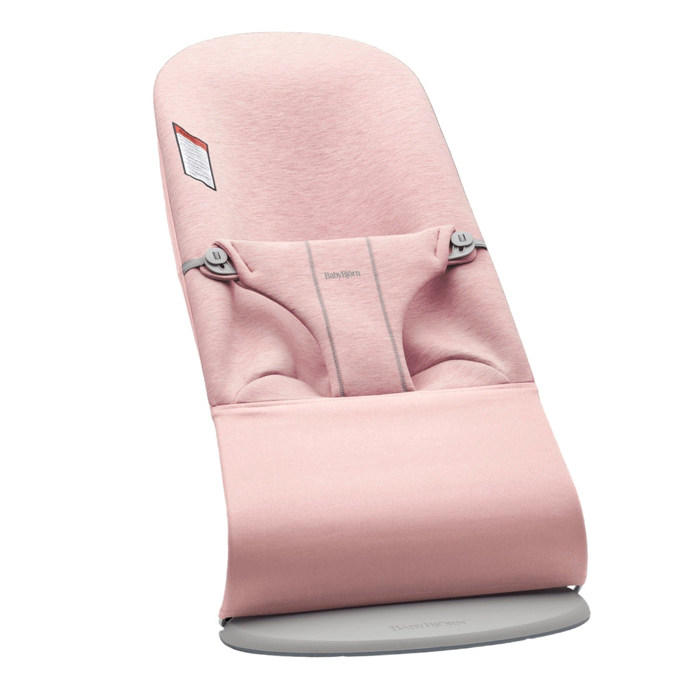 BabyBjorn Bouncer Bliss in pink fabric, mounted on a round gray base for stable use.