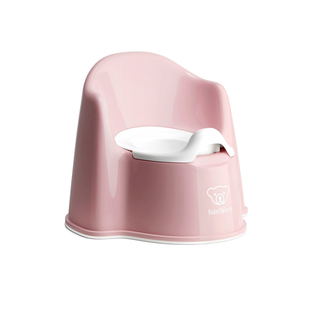 BabyBjorn Potty Chair, pink plastic with white inner seat, toddler-friendly compact design.