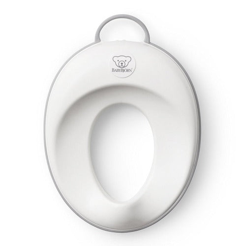 BabyBjorn Toilet Trainer seat in white with grey rim, ready for toddler potty use.