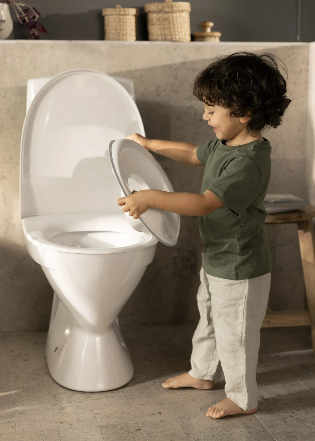 BabyBjörn Toilet Training Seat — official lifestyle view (White/Gray)