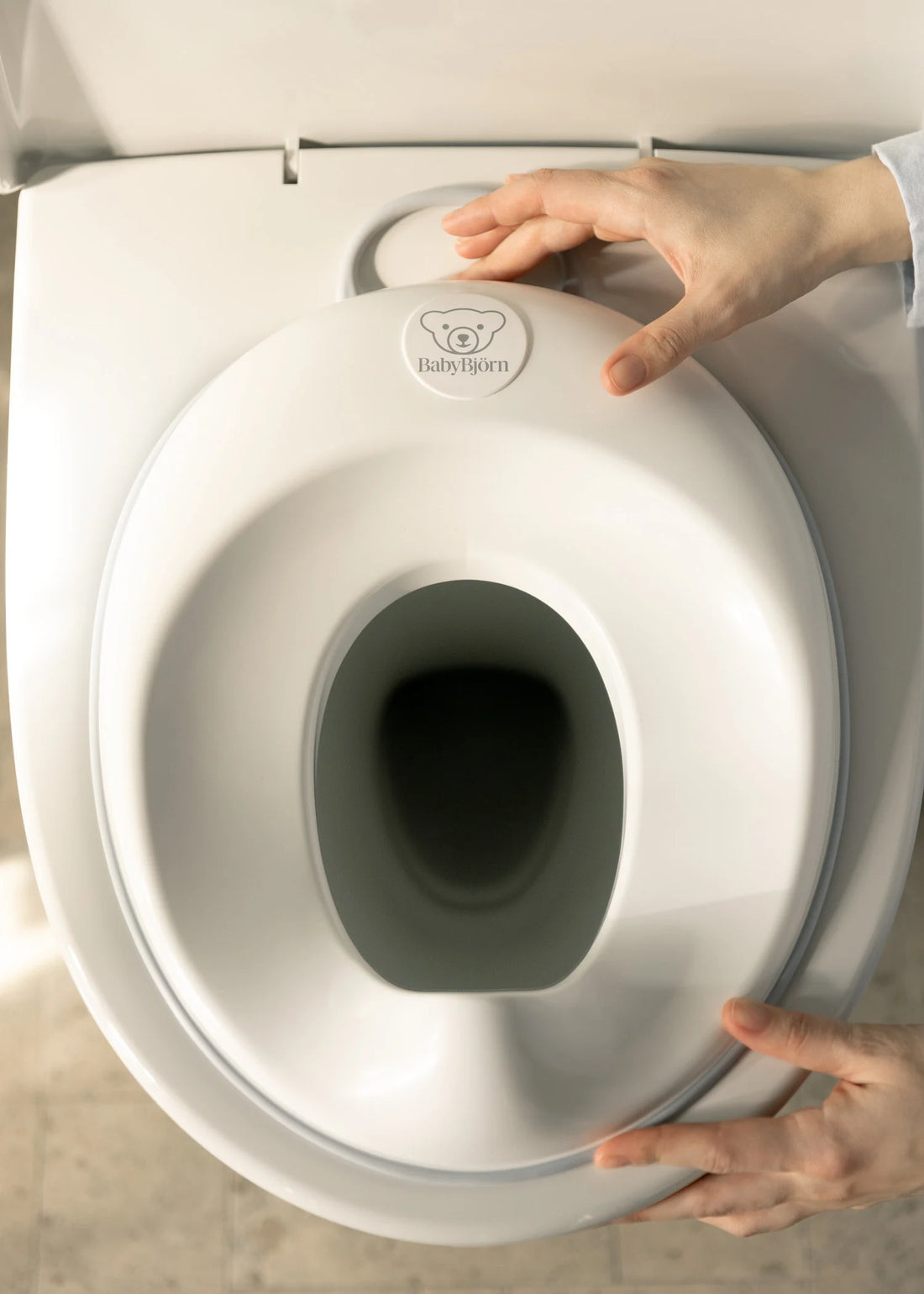 BabyBjörn Toilet Training Seat — Adjustable fit (White/Gray)