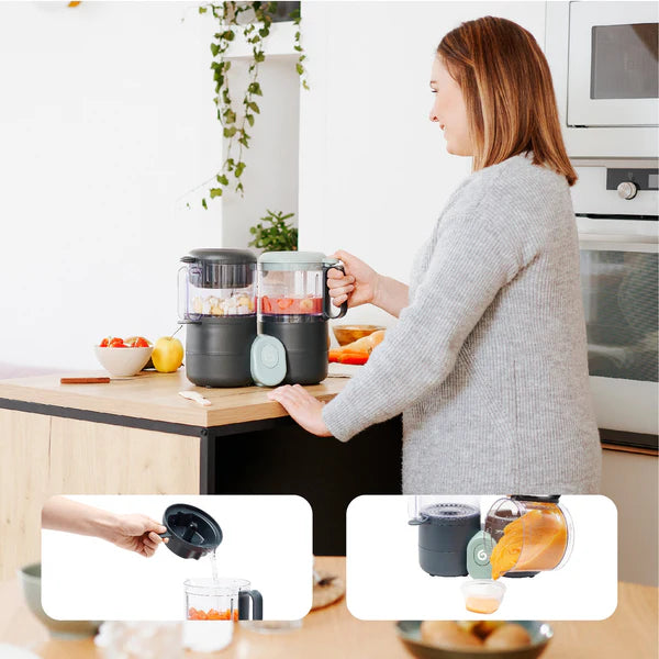 Babymoov Duo Meal Lite baby food maker with two jars on a gray and mint base on a kitchen counter