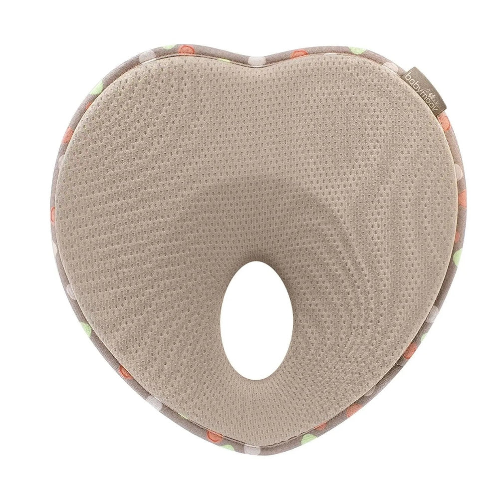 Babymoov Lovenest Pillow, beige breathable fabric, curved head-support with central hole for infant stability.