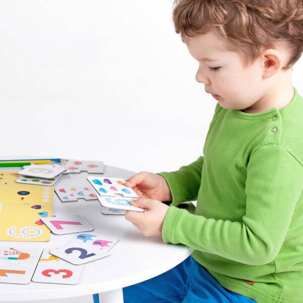 Banana Panda Kids Academy Activity Set: Numbers 3+, child sorting colorful number cards on a white table.