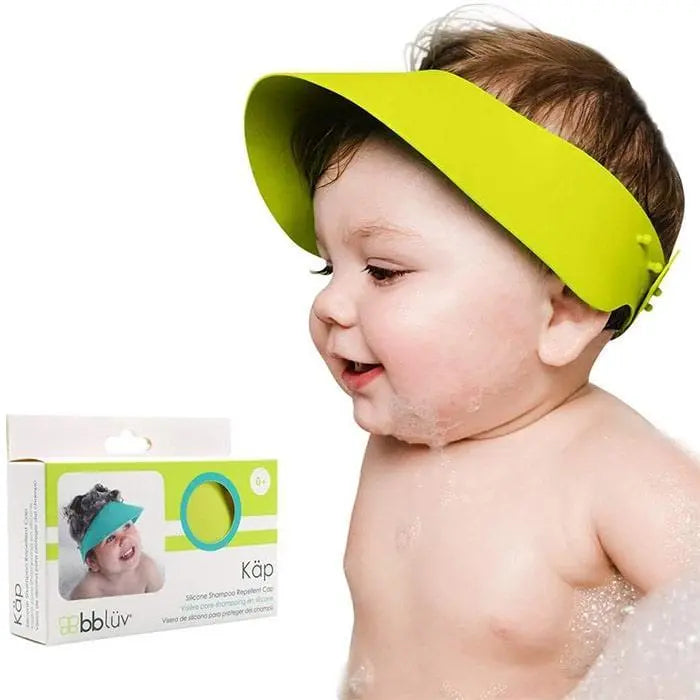 BBLUV Kap Shampoo Repellent Cap worn by smiling baby during bath, lime-green visor keeps soap out.