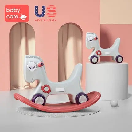 BC BABYCARE 2-In-1 Rocking Horse toy, two gray ponies with red accents riding curved red rockers on a pastel display.
