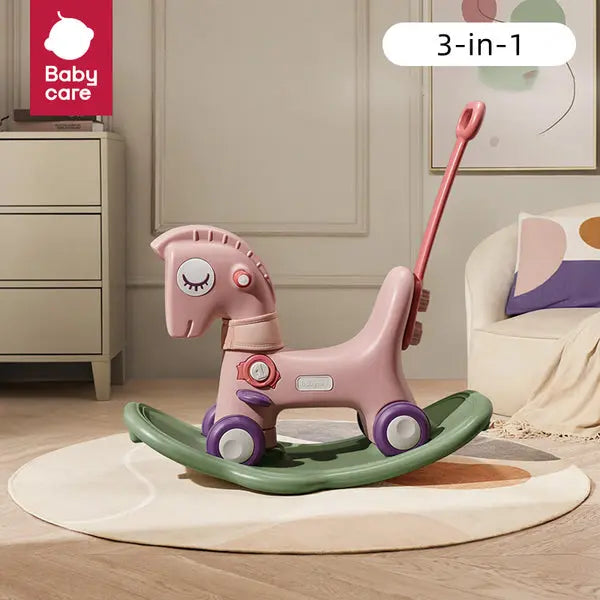 BC Babycare 3-In-1 Rocking & Sliding Horse, pink with purple wheels on a green rocker, ready for indoor ride