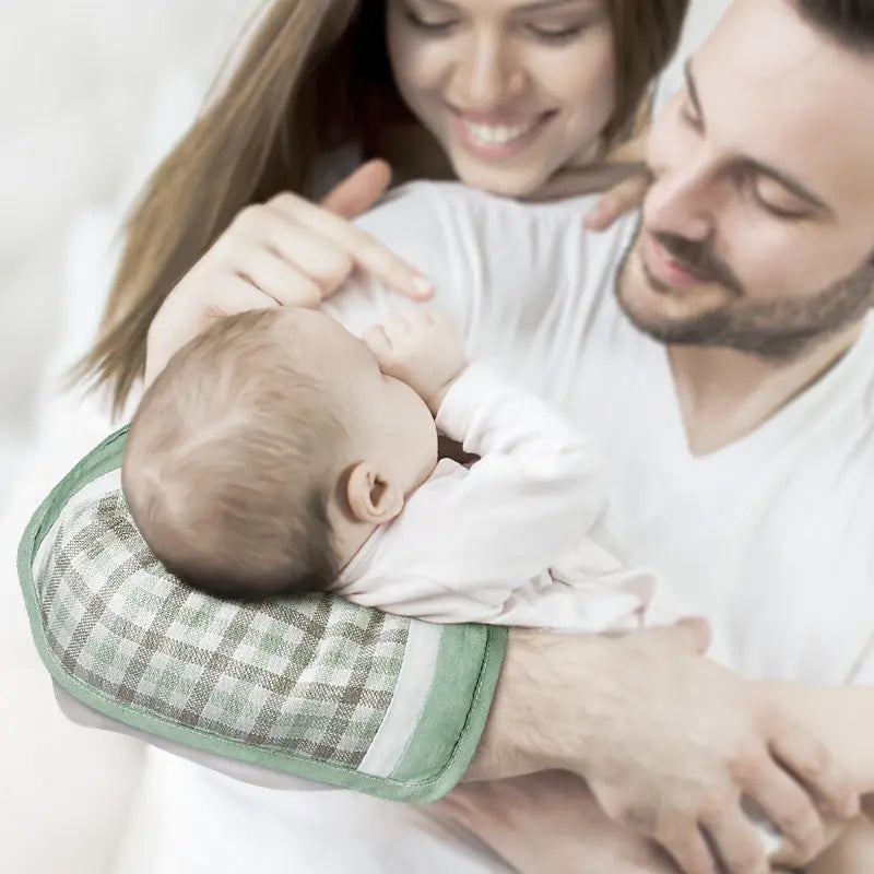 BC Babycare Armrest Summer Cushion supports baby in parents' arms with a green plaid cover, as shown.