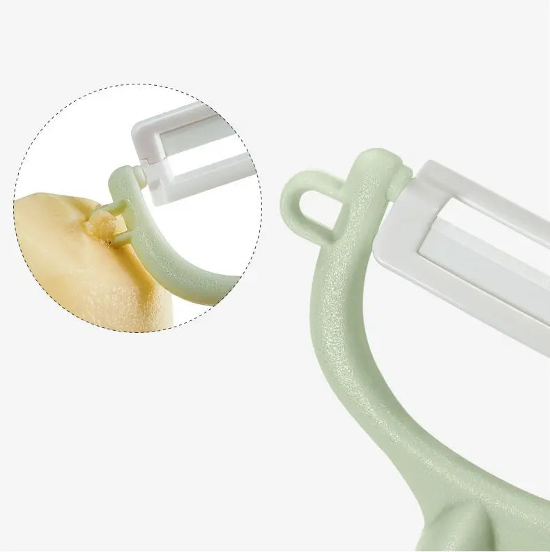 Bc Babycare Baby Food Ceramic Peeler in mint green with a white blade, shown smoothly peeling fruit.