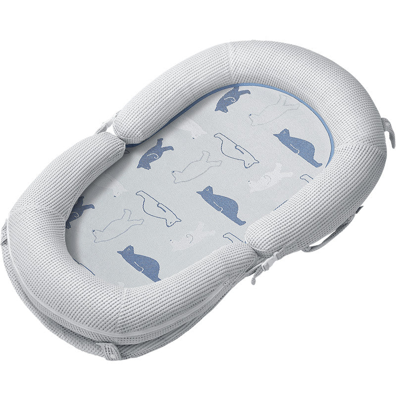 BC Babycare Baby Snuggle Nest in light gray with whale-pattern interior for a cozy, secure infant space.
