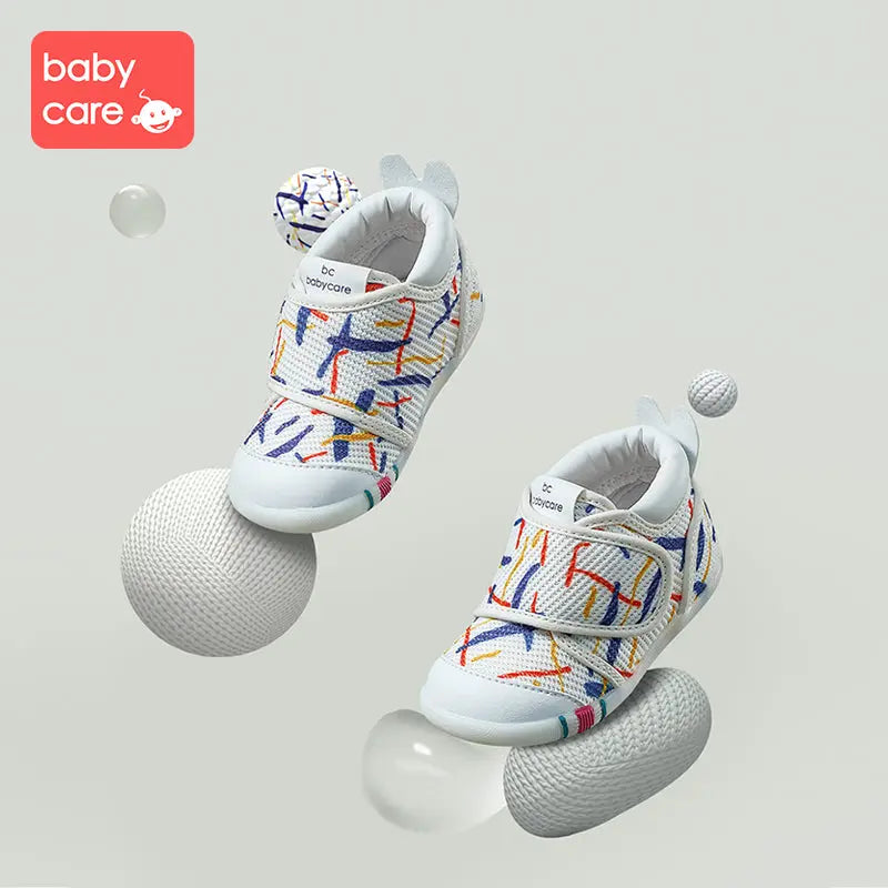 BC Babycare Baby Step One Geometry shoes: white toddler sneakers with colorful geometric print, Velcro straps fastened.