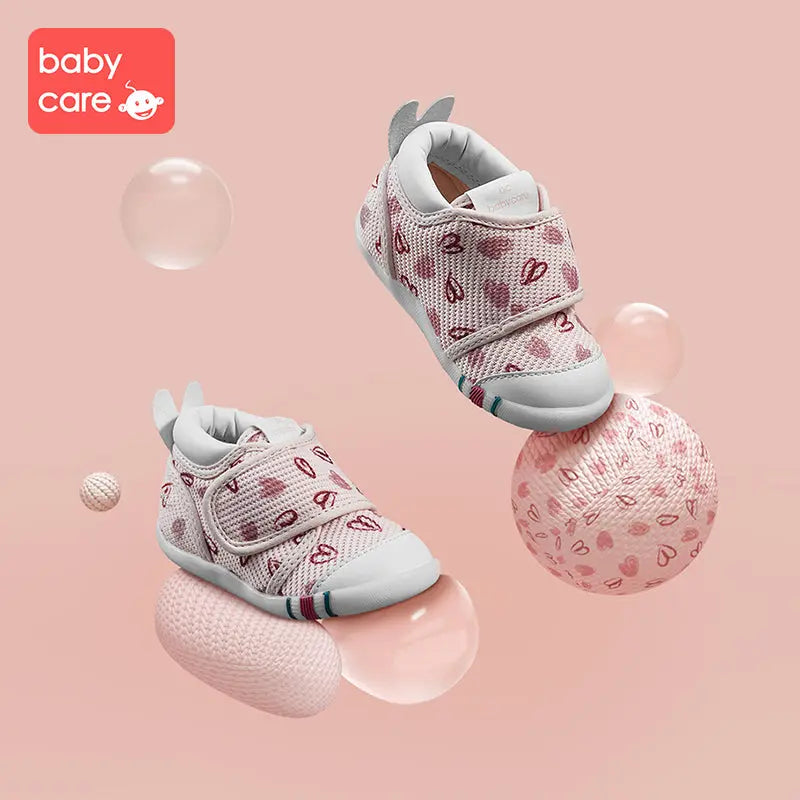 BC Babycare Baby Step One Shoes Hearts pink knit baby sneakers pair with Velcro straps and white soles.