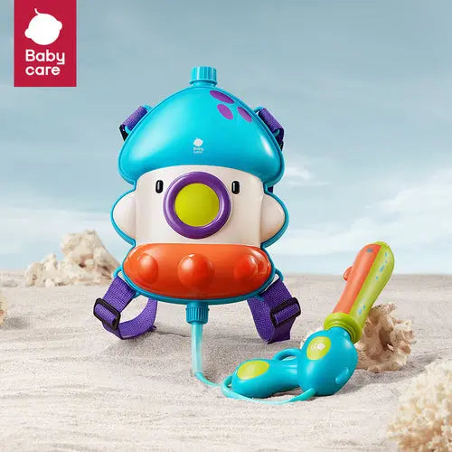 Bc Babycare Backpack Water Blaster 2300 ml on a sunny beach; blue backpack with purple straps powers a connected water gun.