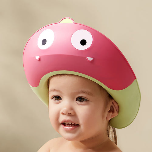BC Babycare Dinosaur Shower Cape Red worn by a smiling toddler during bath time