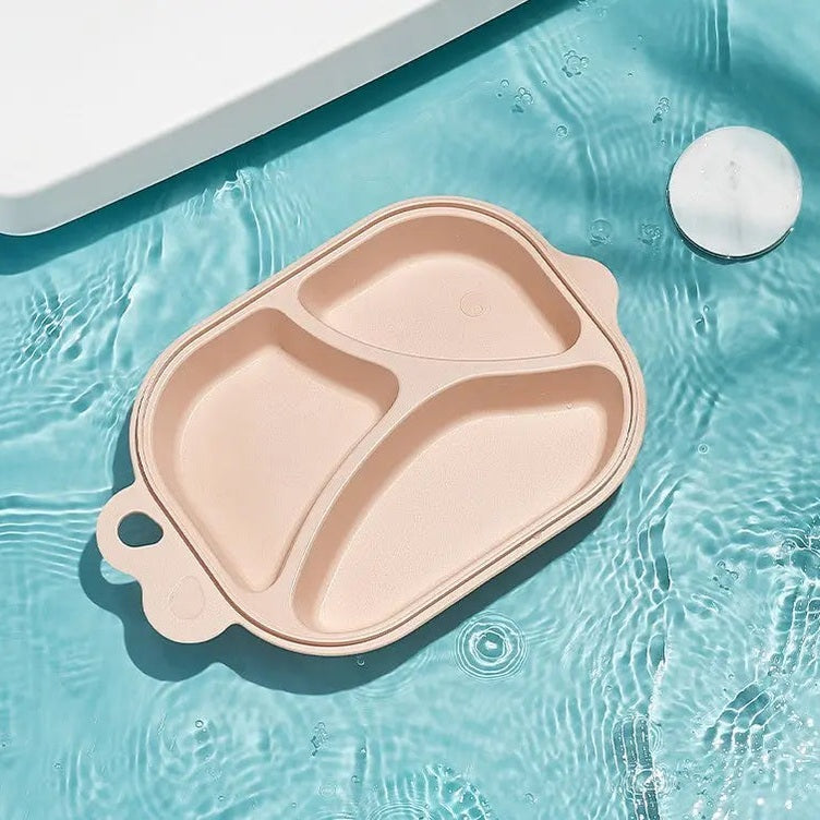 BC Babycare Dividend Plate pink silicone divided feeding plate with three compartments, resting on pool water.