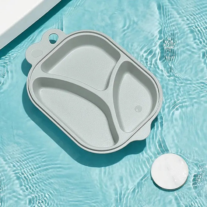 BC Babycare Dividend Plate gray divided baby plate floating on pool water, showing three compartments.