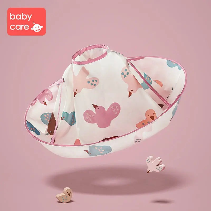 BC Babycare Haircut Cloak, pink-white baby cape with bird pattern, draped open to show wide neck opening.