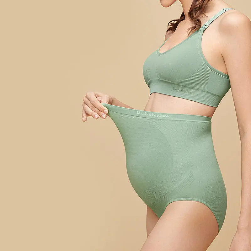 BC Babycare Maternity High Waisted Underwear Cream; pregnant model stretches waistband to show soft, full-coverage fabric.