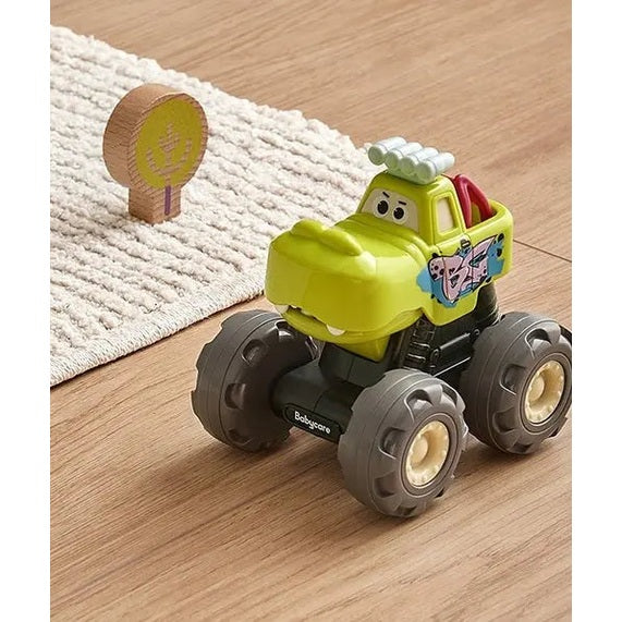 BC Babycare Monster Truck toy on a wooden floor, bright yellow body with oversized gray wheels and side decal.