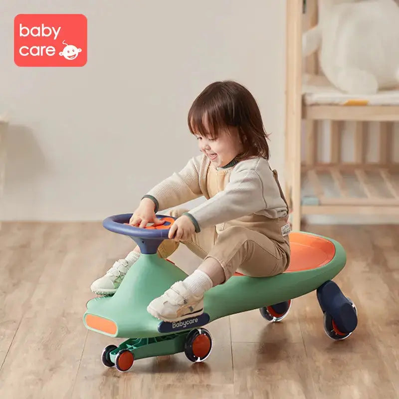 BC Babycare Nyokiroad Wiggle Car; green body, blue steering wheel, orange seat as toddler happily rides.
